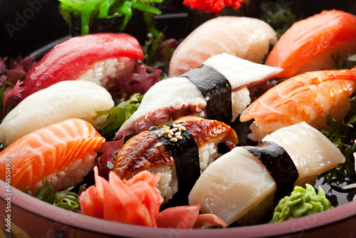 Exquisite Sushi Platter: A Culinary Journey through the Art of Japanese Cuisine. Dive into the vibrant world of sushi, beautifully arranged in a circular pattern. Experience the freshness of salmon