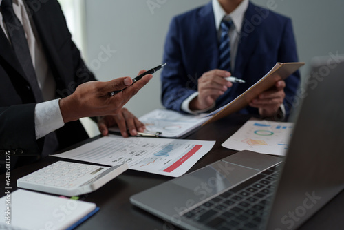 Business People Meeting to analyse and discuss and brainstorming the financial report chart data in office Financial advisor teamwork and accounting concept. © crizzystudio