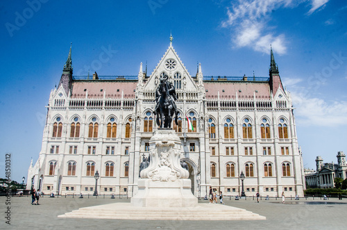 Budapest, Hungary, August 15, 2023. Facade of Budapest Parliament and Bronze Monument.