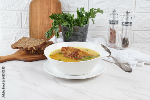 Pea soup with smoked pork ribs served in white bowl