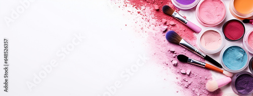 colorful pink and red color cosmetic powders and lids on a table wide banner with empty space at the left side