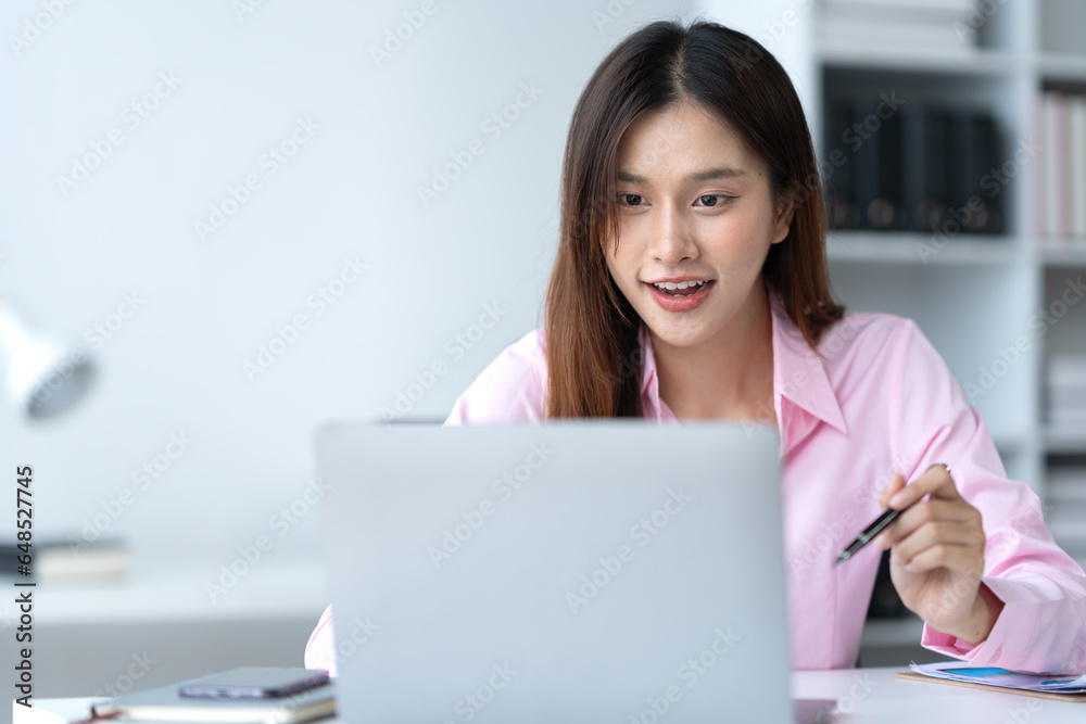 Beautiful asian businesswoman working on laptop and calculating with financial calculator from statistics data graphs, charts. Successful business results in modern office with joy. Beautiful asian businesswoman working on laptop and calculating with financial calculator from statistics data graphs, charts. Successful business results in modern office with joy.