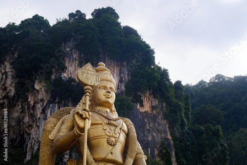 Batu caves in Malaysia, gold indian statue of Lord Murugan © nexusby