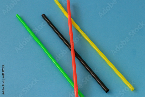 Different coloured straws with different patterns photographed on background isolated.