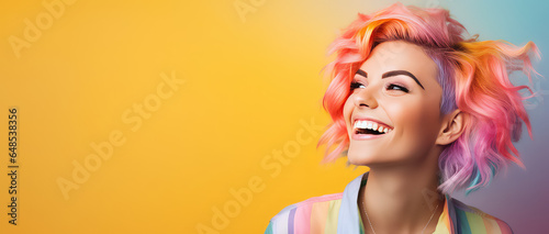 Young beautiful smiling happy woman with rainbow colored wavy hair isolated on flat yellow background with copy space, banner template of Creative hair coloring.
