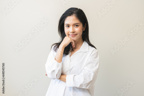 Smile positive, happy asian young woman wearing casual shirt, portrait of beautiful female with black long hair feeling prond, standing crossed arms looking at camera, isolated on white background.