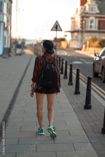 Tourist woman walking away. Beautiful tourist woman in the street