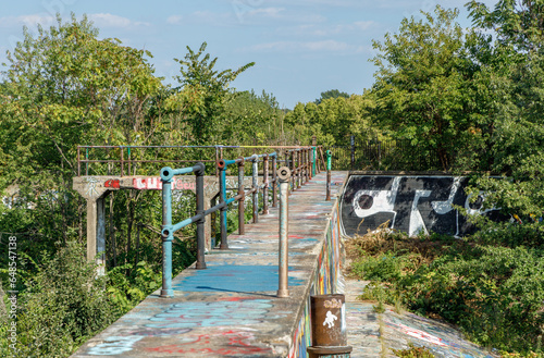 Walkway covered in graffiti at abandoned reservoir photo