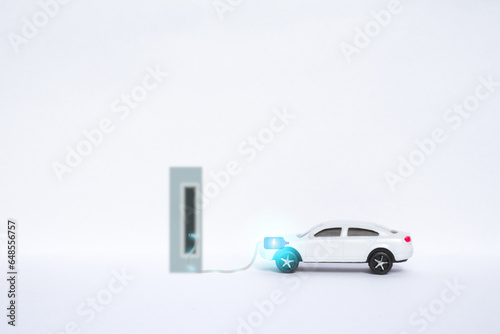 Electric car connected to power station charging the battery. New technology of vehicle industry, charging power instead of fuel refilling for ecology sustainability.