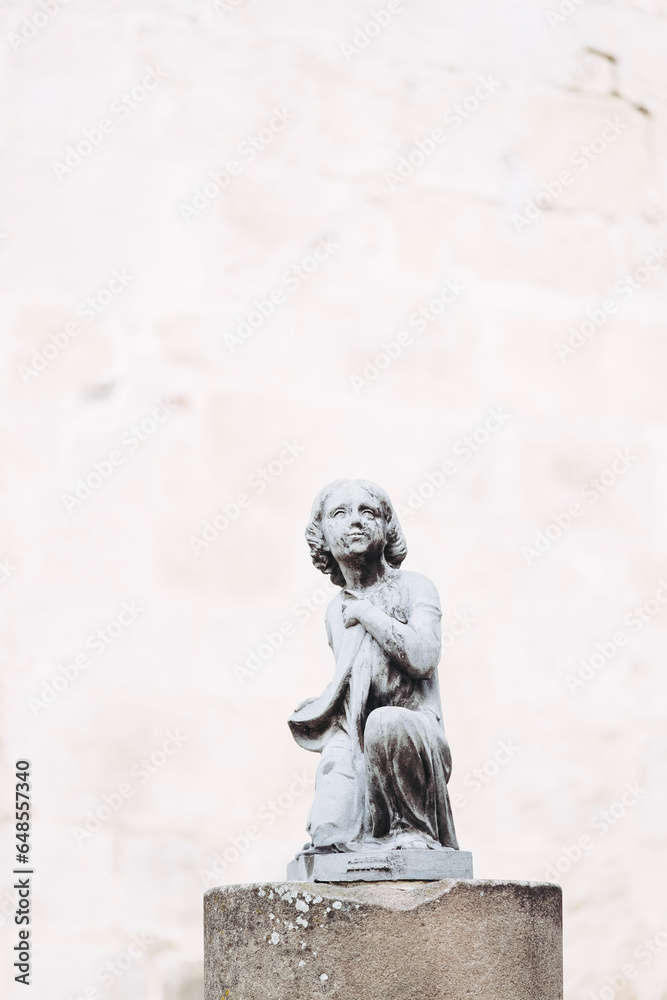 Naklejka premium Statue en pierre représentant un enfant dans un parc en France