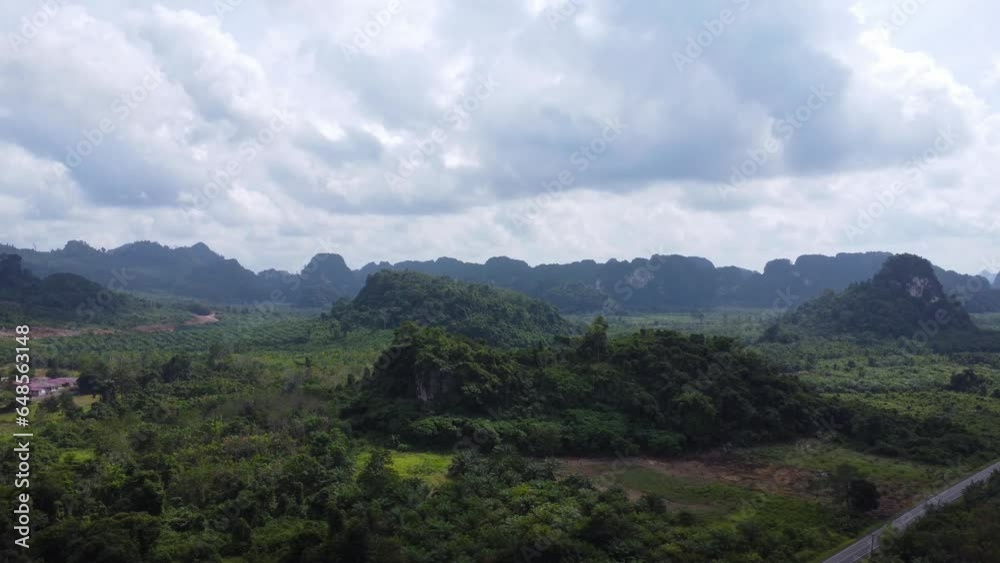 Aerial view of the rocky mountains in South Kalimantan which are filled with plants and surrounded by oil palm plantations Aerial view of the rocky mountains in South Kalimantan which are filled with plants and surrounded by oil palm plantations