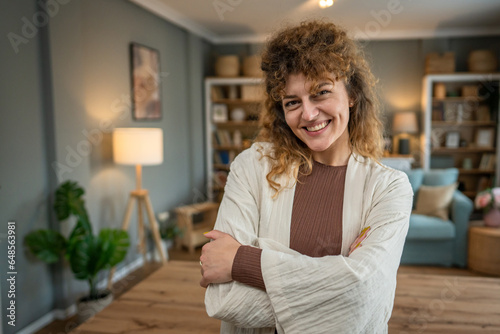 Portrait of one adult caucasian woman at home happy smile curly hair