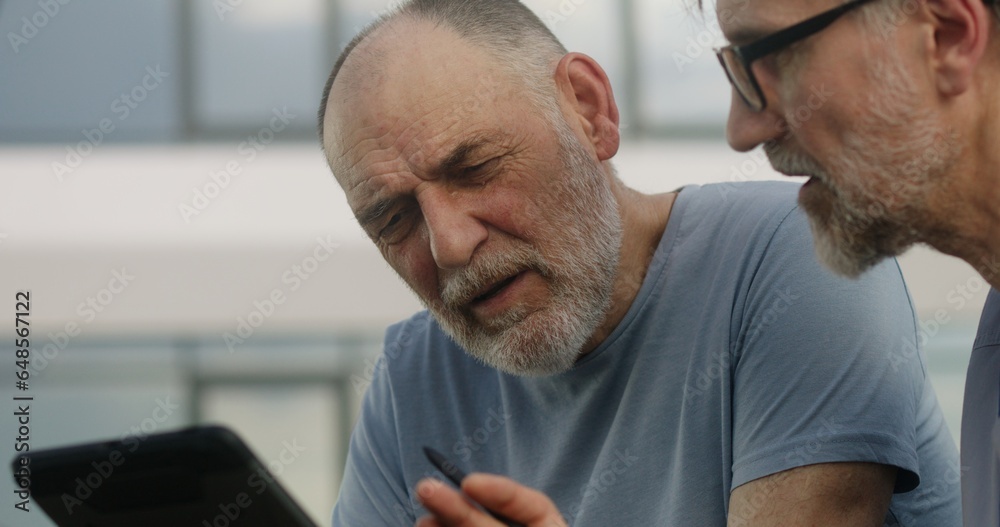 Health care specialist sits with aged patient on bench and discusses his treatment. Elderly man complains of shoulders and heart pains to doctor. Mature medic examines client outdoor. Slow motion. Health care specialist sits with aged patient on bench and discusses his treatment. Elderly man complains of shoulders and heart pains to doctor. Mature medic examines client outdoor. Slow motion.
