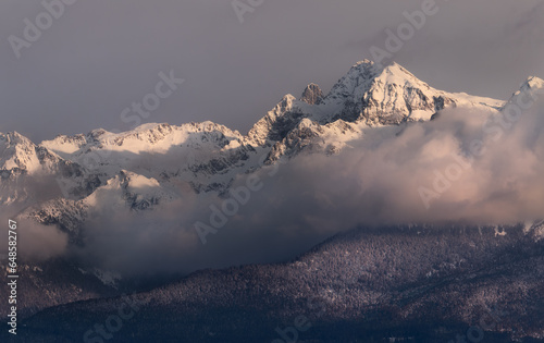 snow covered mountains with low clouds 