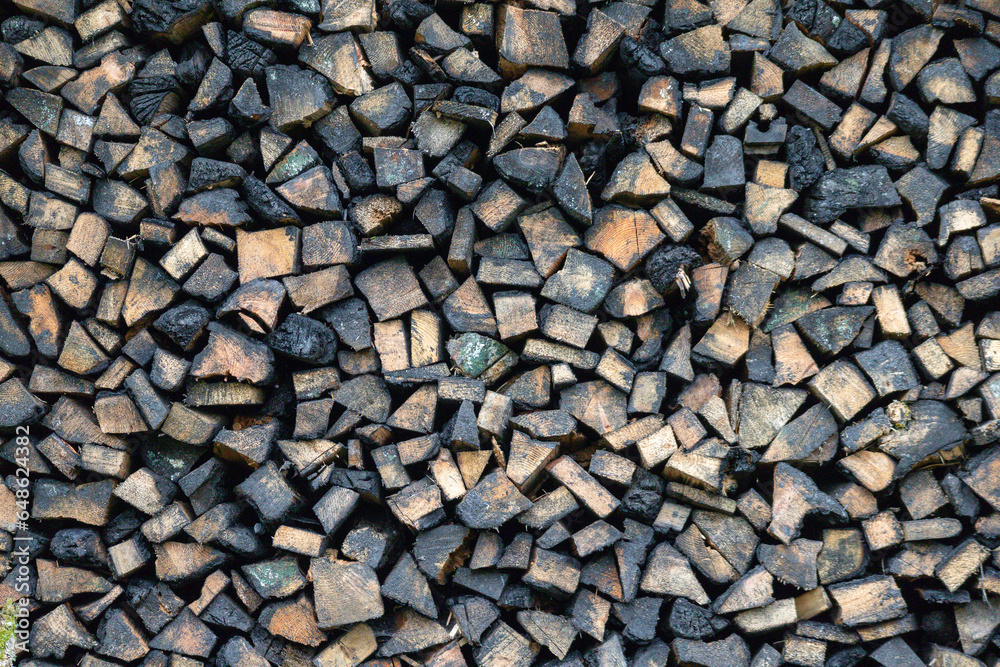 Chopped logs of firewood piled on top of each other
Chopped logs of firewood piled on top of each other