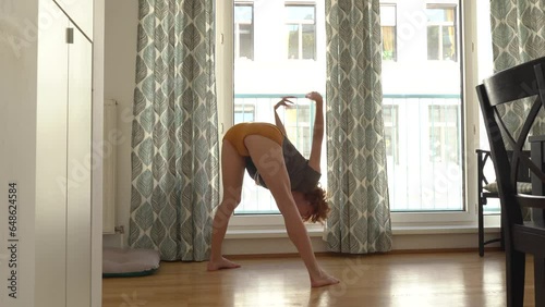 Young woman doing stretching at home photo