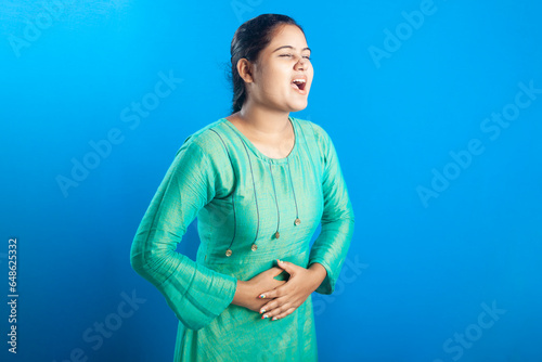 Beautiful women holding her belly suffering from stomachache or PMS with painful expression photo