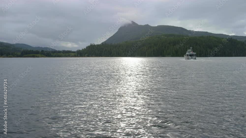 Boat in calm seas driving out to mountains Boat in calm seas driving out to mountains