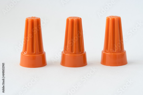 Three Orange Plastic Electrical Caps