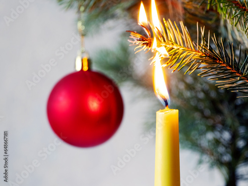 Obraz na plátne A branch of a Christmas tree caught fire from a candle, a fire due to non-compli