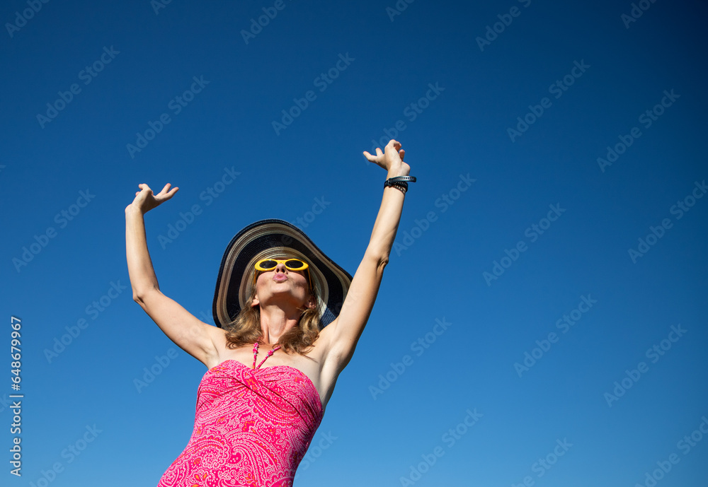 happy woman in pink swimsuit against blue sky holiday concept happy woman in pink swimsuit against blue sky holiday concept