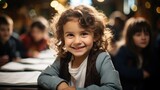 Smiling girl sitting in a classroom desk