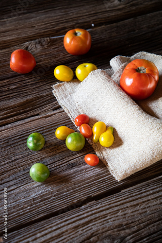 fresh organic tomatoes on wooden background