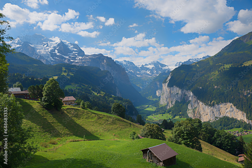 stunning view to Lauterbrunnen valley over green slopes, swiss alps landscape