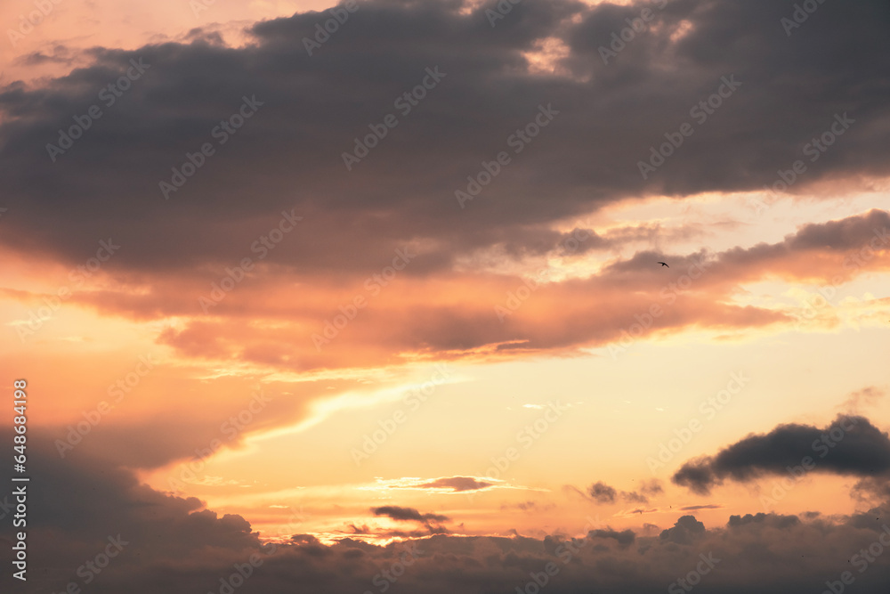 sunset view behind clouds at golden hours