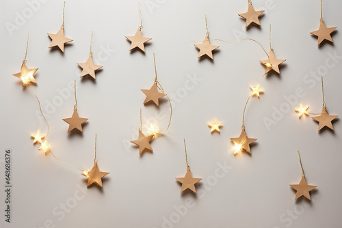 Warm star-shaped light garlands, festive decorations with copy space. Christmas concept. Flat lay, top view