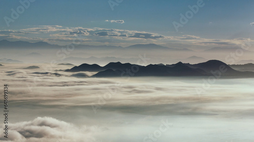 Morning vista view of Lake Elsinore basin filled with fog and low clouds.