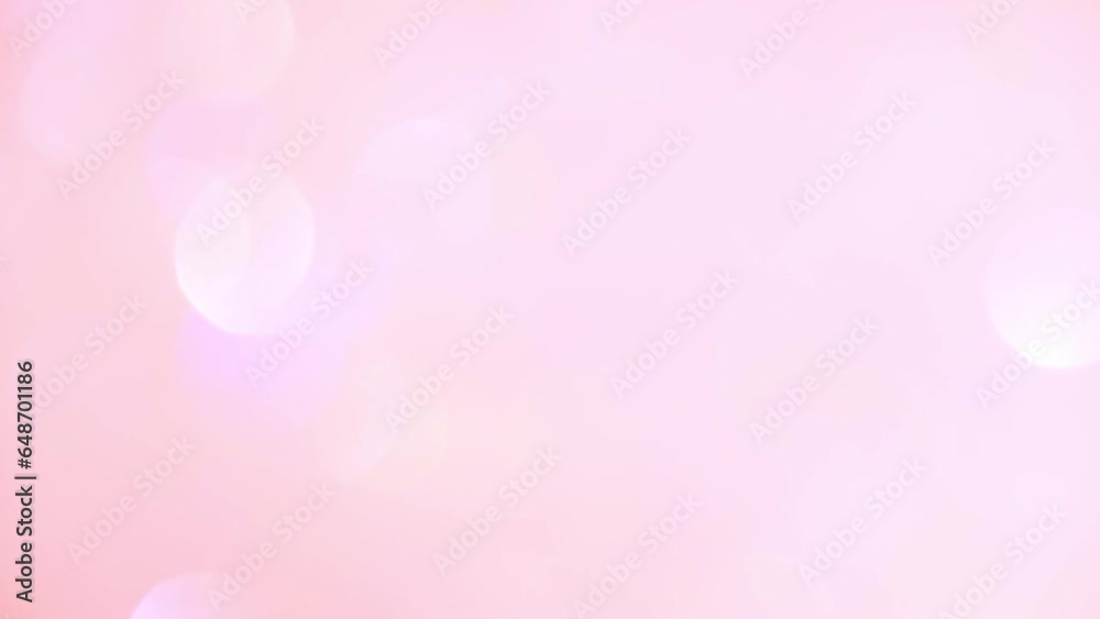 Shimmer and movement of bokeh on pink. Abstract background of blurred lights.
