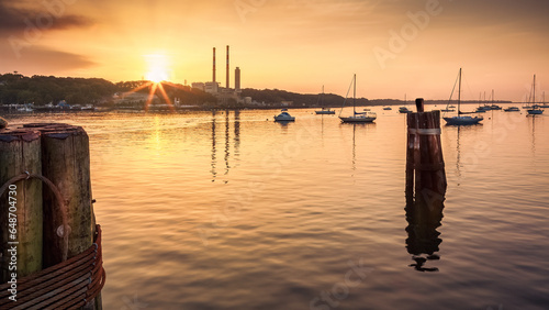 Port Jefferson, New York marina at sunset. Port Jefferson was settled in the 17th century and remained a rural community until its development as a shipbuilding center in the mid 19th century. photo