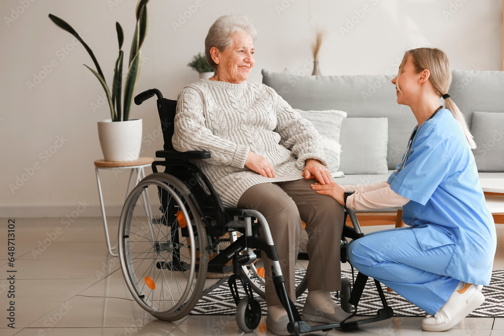 Young caregiver with senior woman in wheelchair at home Young caregiver with senior woman in wheelchair at home