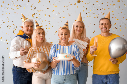 Mature people with cake and...