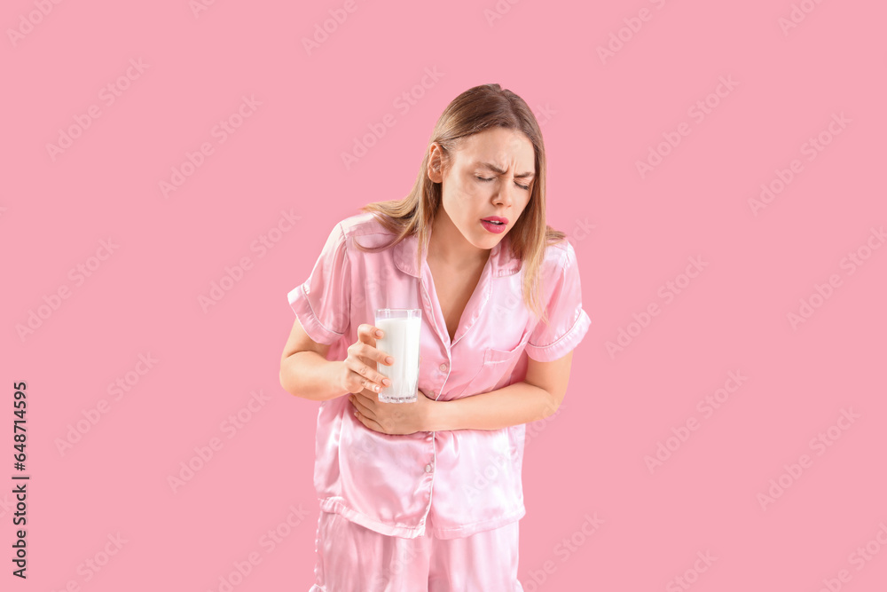 Young woman with lactose intolerance on pink background Young woman with lactose intolerance on pink background