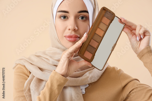 Young Muslim woman with mak...