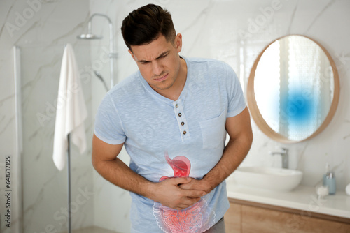 Healthcare service and treatment. Man suffering from abdominal pain in bathroom. Illustration of gastrointestinal tract photo