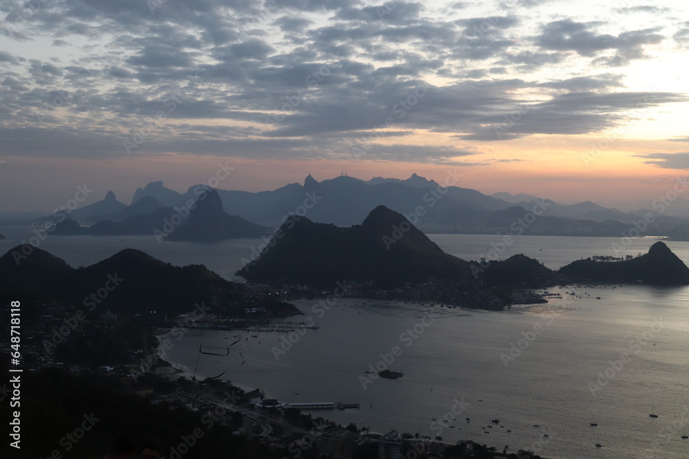 Linda paisagem do céu e montanhas ao entardecer com bastante nuvens, oceano e morros famosos do Rio de Janeiro