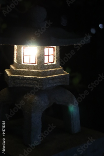 Lâmpada em formato de mini casa, acesa a noite, estilo chinês em uma rua deserta