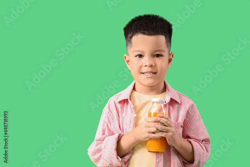 Little Asian boy with bottl...
