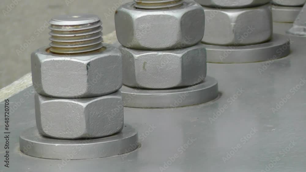 securing the base of a large metal structure with bolts securing the base of a large metal structure with bolts
