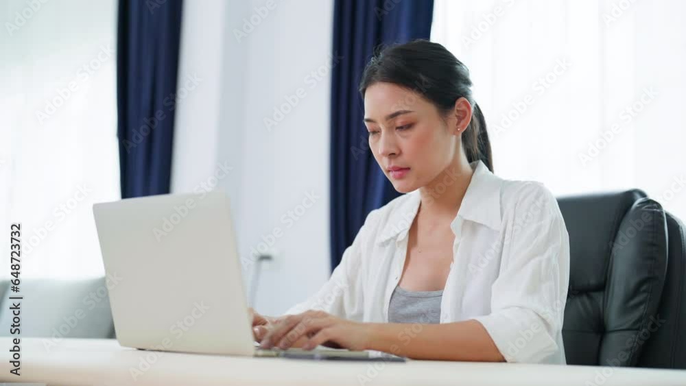 Young asian woman working on computer laptop at home Young asian woman working on computer laptop at home
