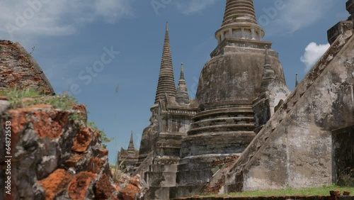 Low-angle shot ruins of main ancient stone temple in historical park at daylight, The Ayutthaya Kingdom interesting and unforgetable experience, World Heritage concept photo