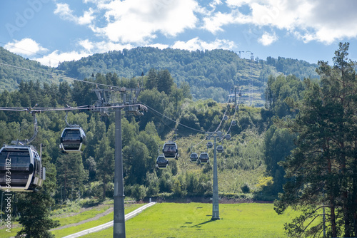 19.08.2023, Manzherok resort, Russia. Close-up of a cable car cabin against the sky. Cable car trip to viewpoints in the mountains. During the trip by cable car Tourists enjoy beautiful views  photo