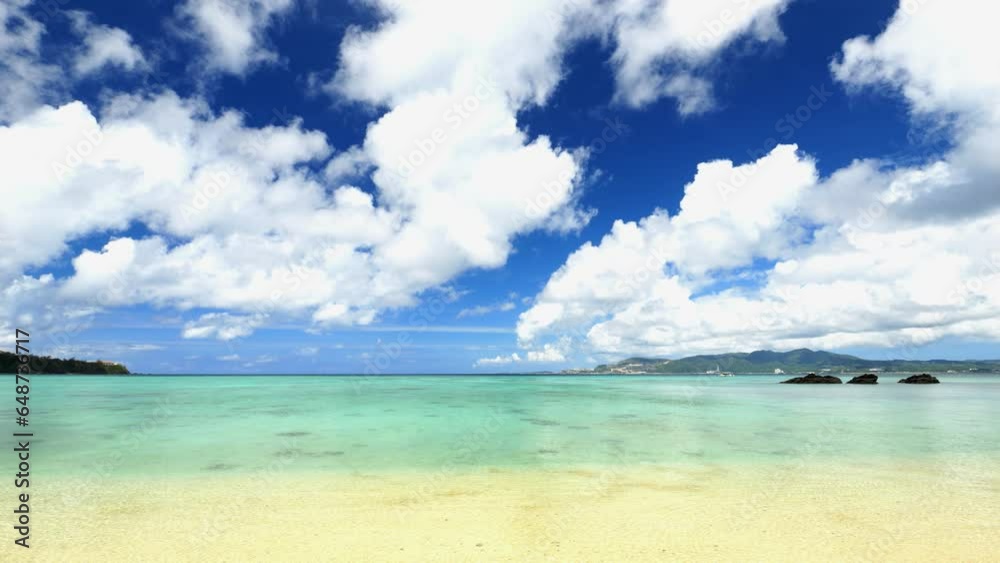 Beautiful view of tropical blue sea or ocean by the white beach and floating clouds in summer, Okinawa in Japan, Nobody, Landscape or travel Beautiful view of tropical blue sea or ocean by the white beach and floating clouds in summer, Okinawa in Japan, Nobody, Landscape or travel