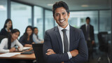 portrait of a smiling businessman, A smile of an Asian Indian businessman in his stylish office, surrounded by his co workers, symbolizing leadership