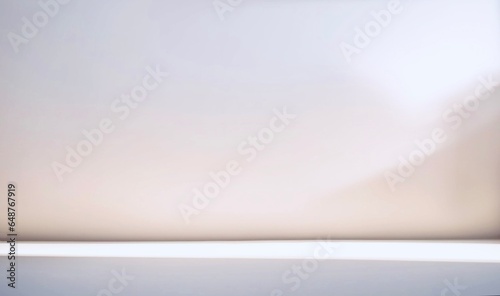 Minimalistic abstract light pearl color background for product presentation. Incident light from the window on the wall and floor.