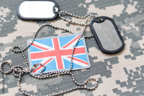 Fotografiet army blank, dog tag with flag of great britain on the khaki texture background