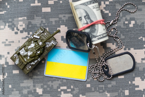 Military ID tags and patch on pixel Ukrainian camouflage, closeup no war